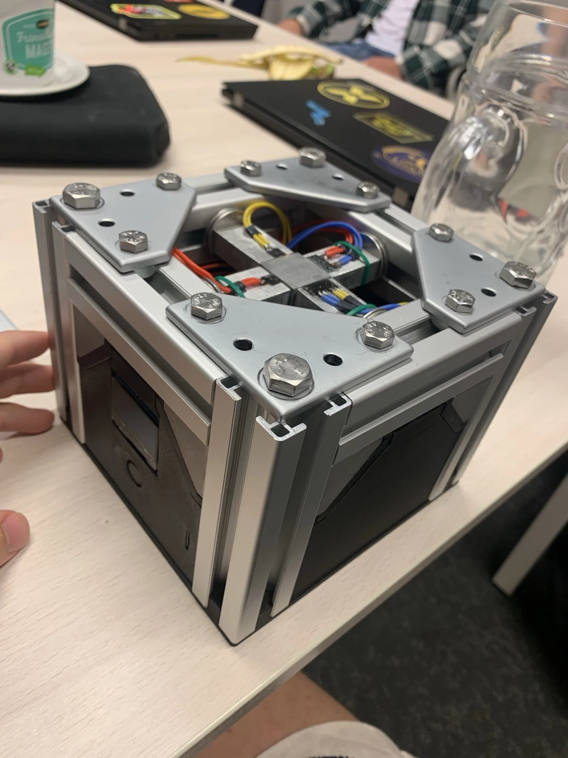 Assembled accelerometer in an aluminium extrusion enclosure on a work table.