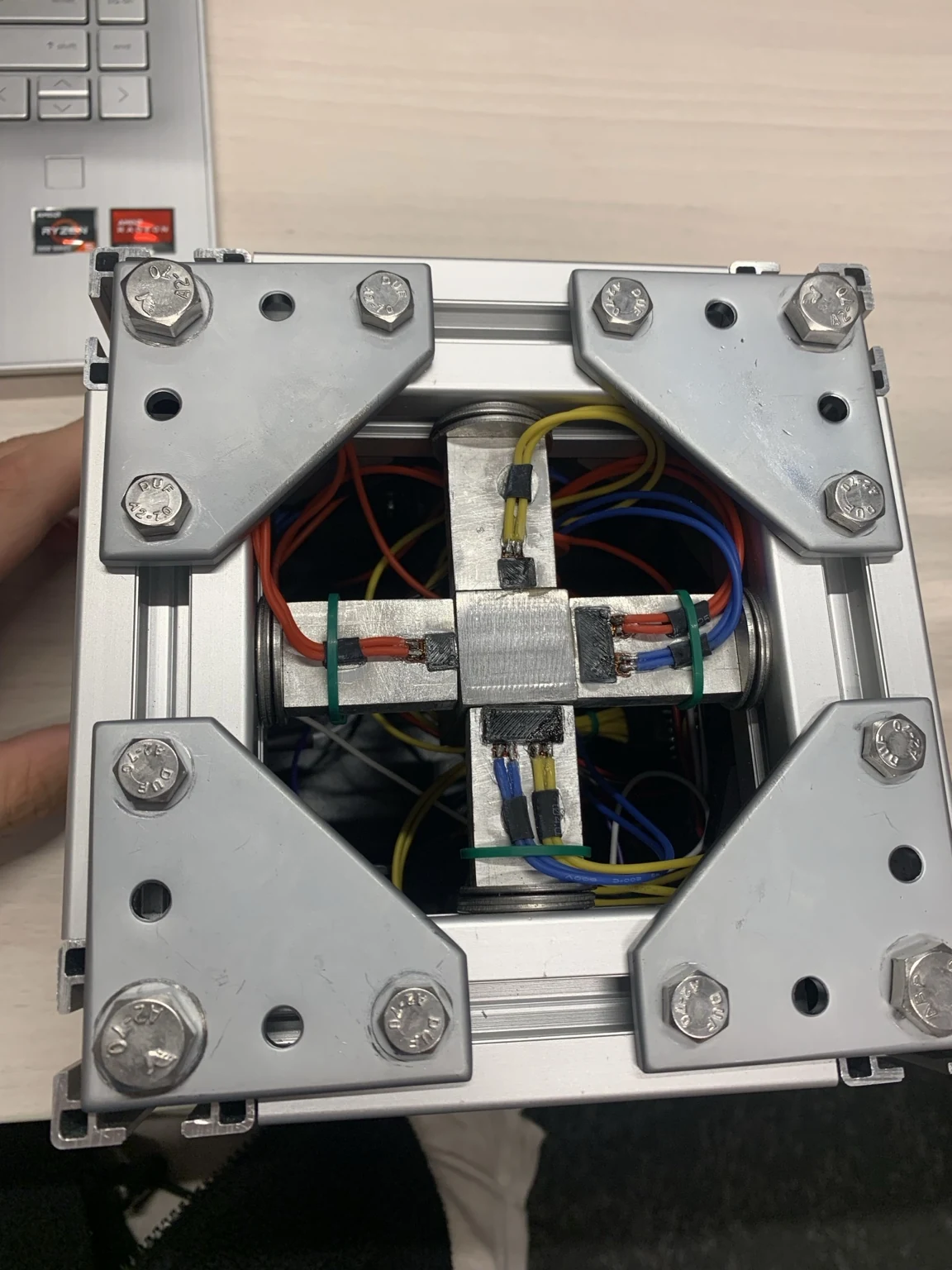 Top view of the accelerometer showing four aluminium beams and coloured strain-gauge wiring.
